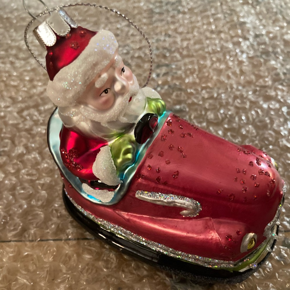 Santa riding a bumper car glass Christmas Ornament